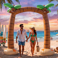 Inflatable palm tree archway on a beach at sunset