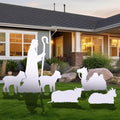White nativity silhouettes of a shepherd and sheep on a front lawn