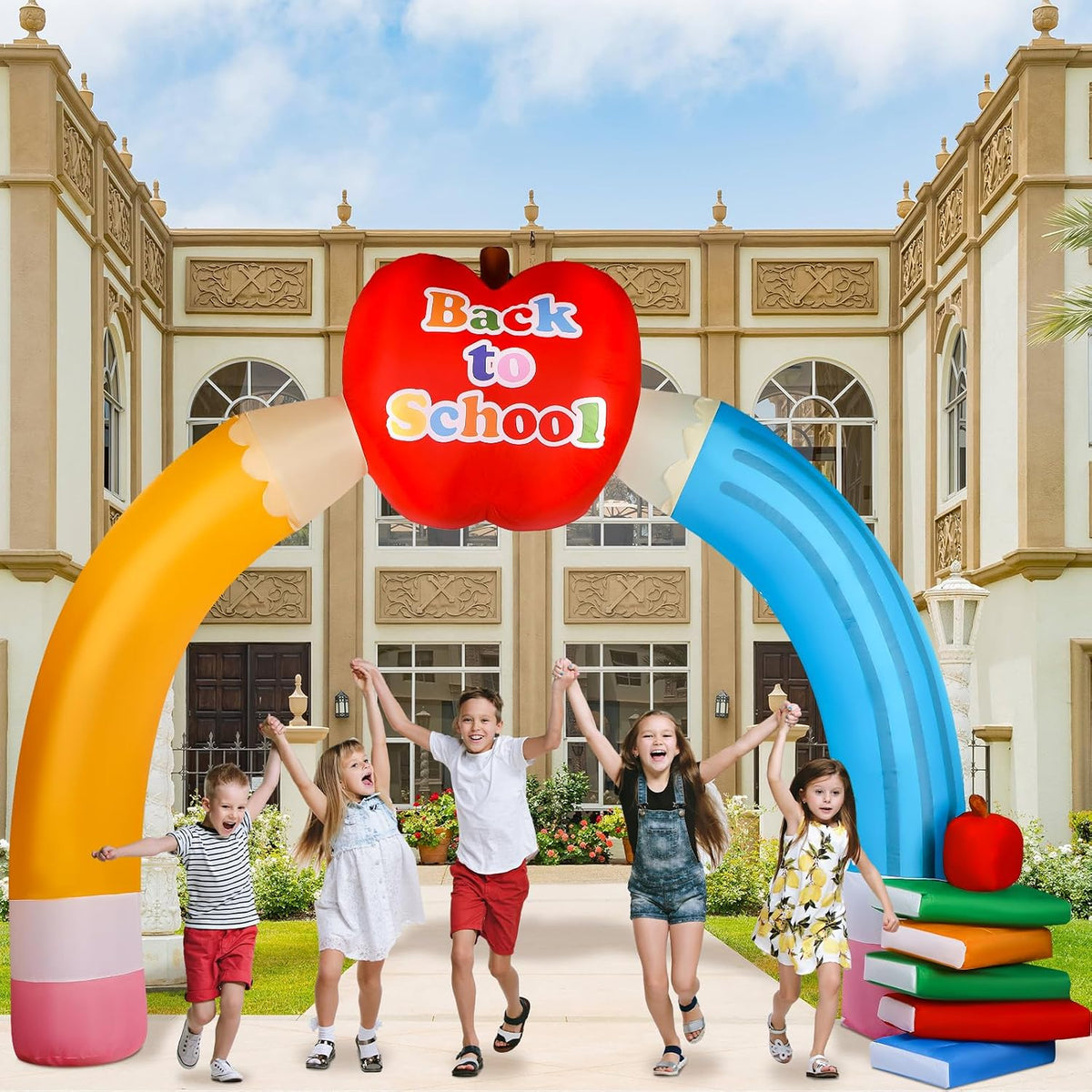 Inflatable pencil archway with an apple sign in front of a school